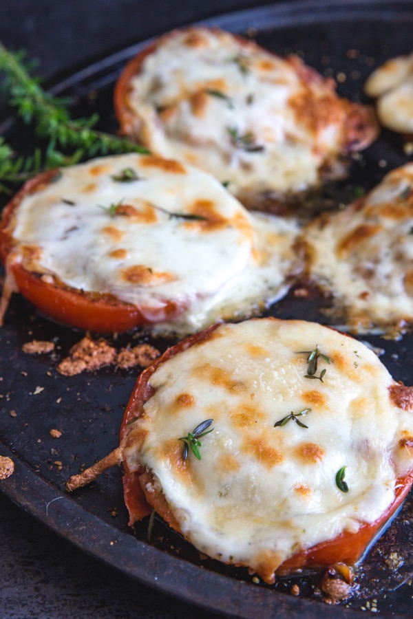 baked tomatoes on a black pan