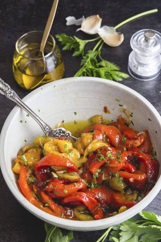 Roasted peppers in a white bowl.