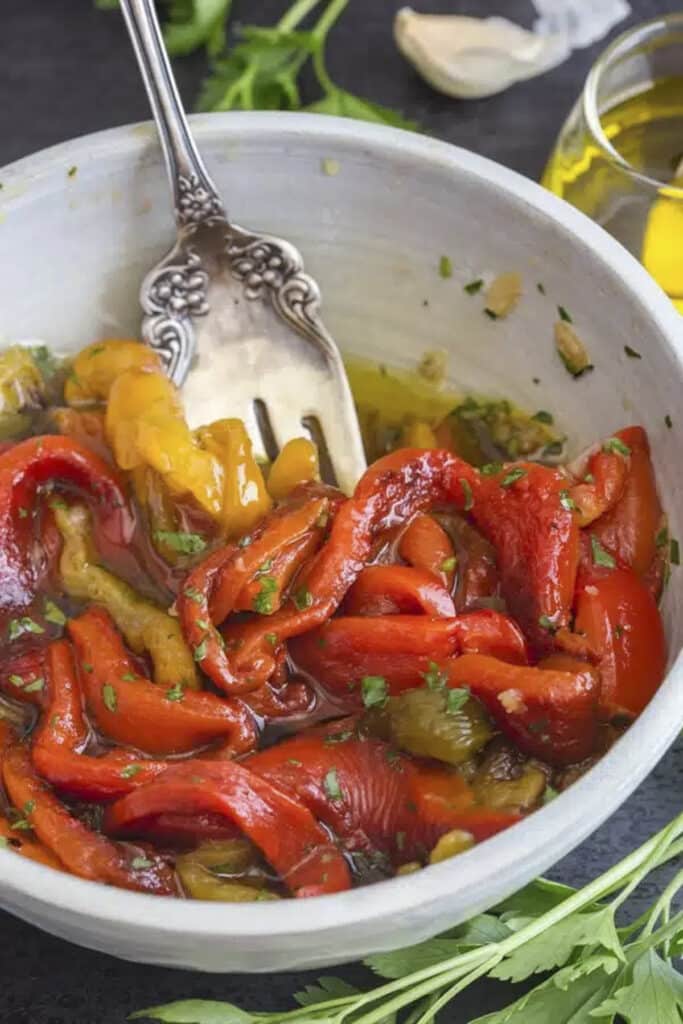 Peppers in a white bowl with a fork.