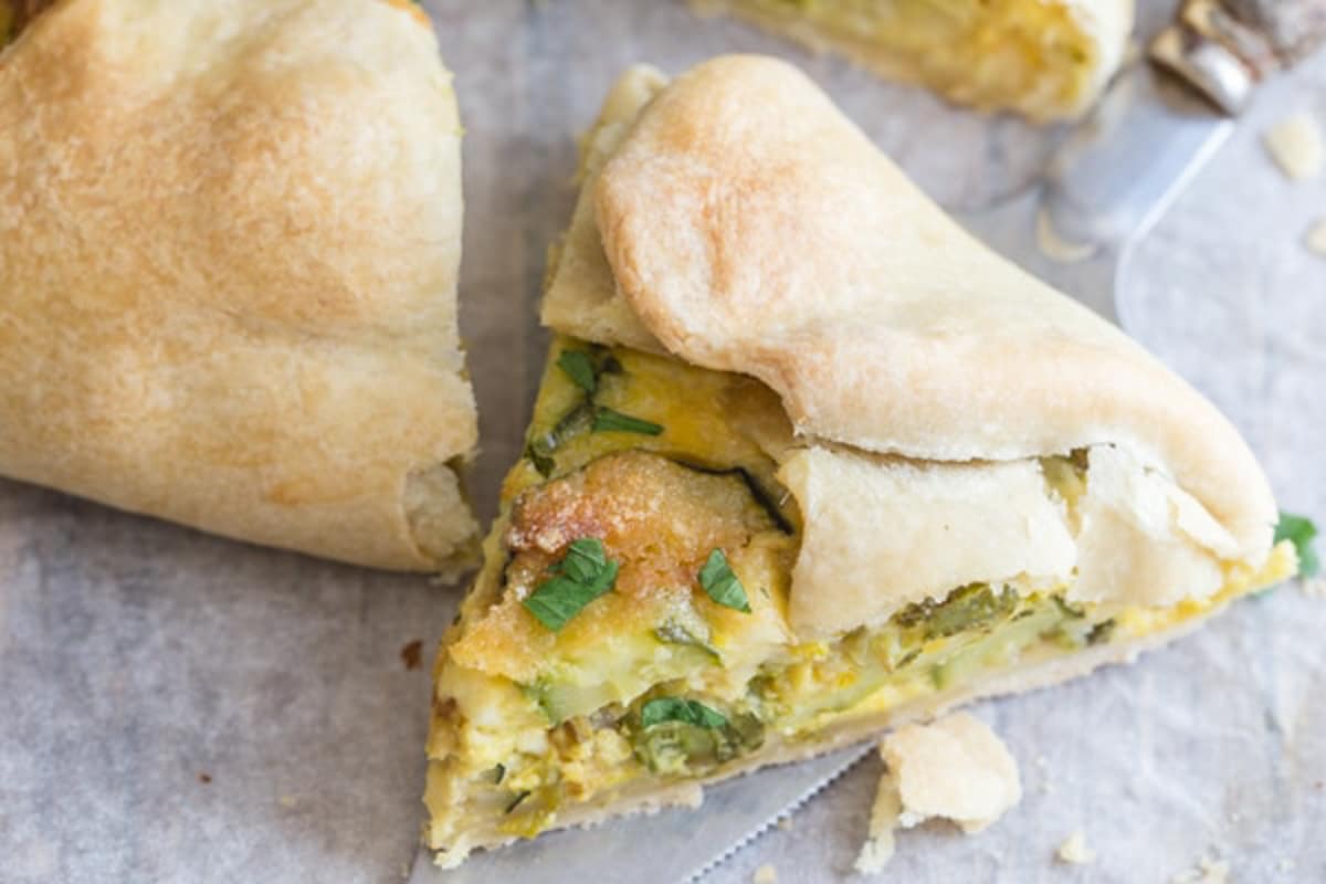 Zucchini pie slice on parchment paper.