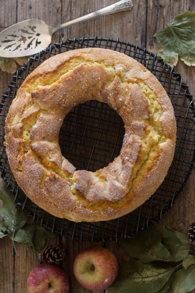 Apple cake on a black wire rack.