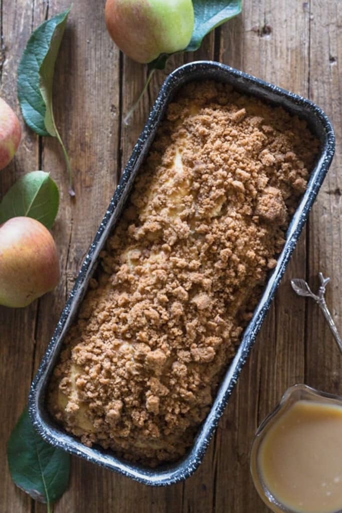 Apple bread in a black loaf pan.