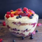 berry trifle in a glass bowl with fresh fruit on top