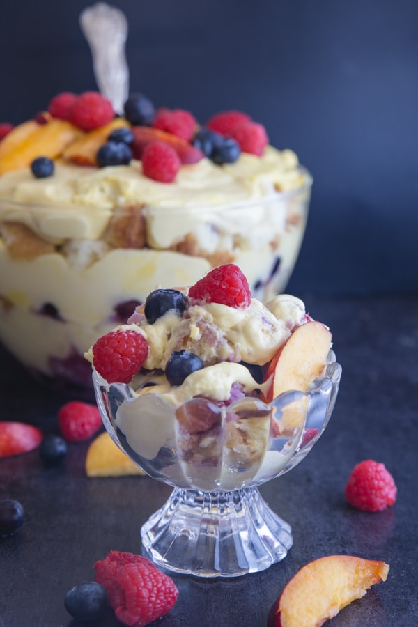 berry trifle in a bowl and some in a serving bowl