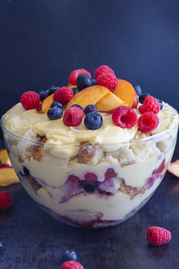 berry trifle in a glass bowl with fresh fruit on top 