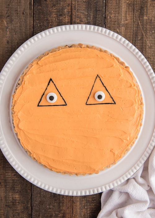 Adding the black triangle and eyes to the cake.