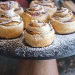 peach puff pastry roses on a black cake stand