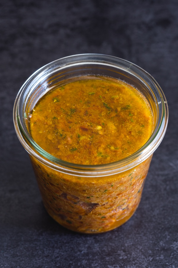 sun-dried tomato pesto in a glass jar covered with oil