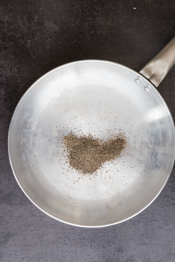ground pepper in a silver pan