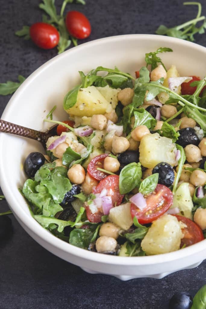Chickpea salad in a white bowl.