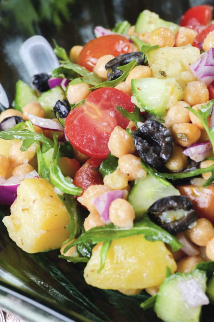 Chickpea salad in a glass bowl.