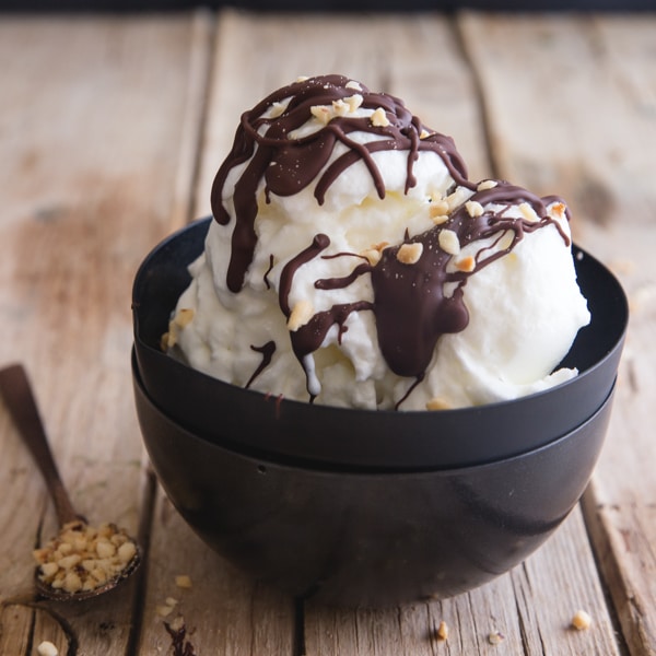 fior di latte drizzle with chocolate in a black bowl