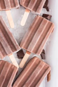 Fudgesicles on ice on a white tray.