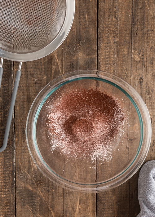 The dry ingredients sifted in a glass bowl.