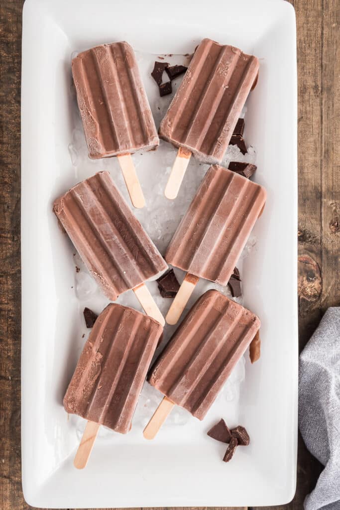 Fudgesicles on ice on a white dish.