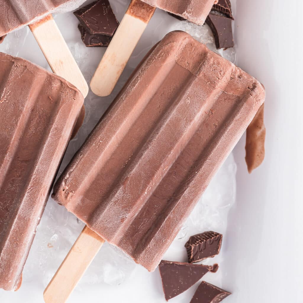 Fudgesicles on ice on a white tray.