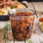 roasted tomatoes under oil in a glass jar