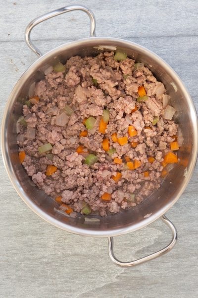 Add the ground beef and pork to the vegetables.