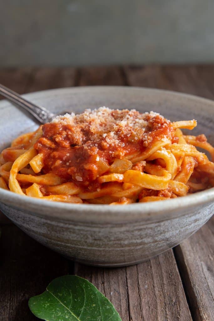 Bolognese sauce in a grey bowl.