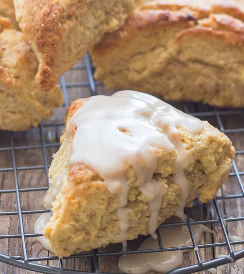 A cinnamon scone on a wire rack.