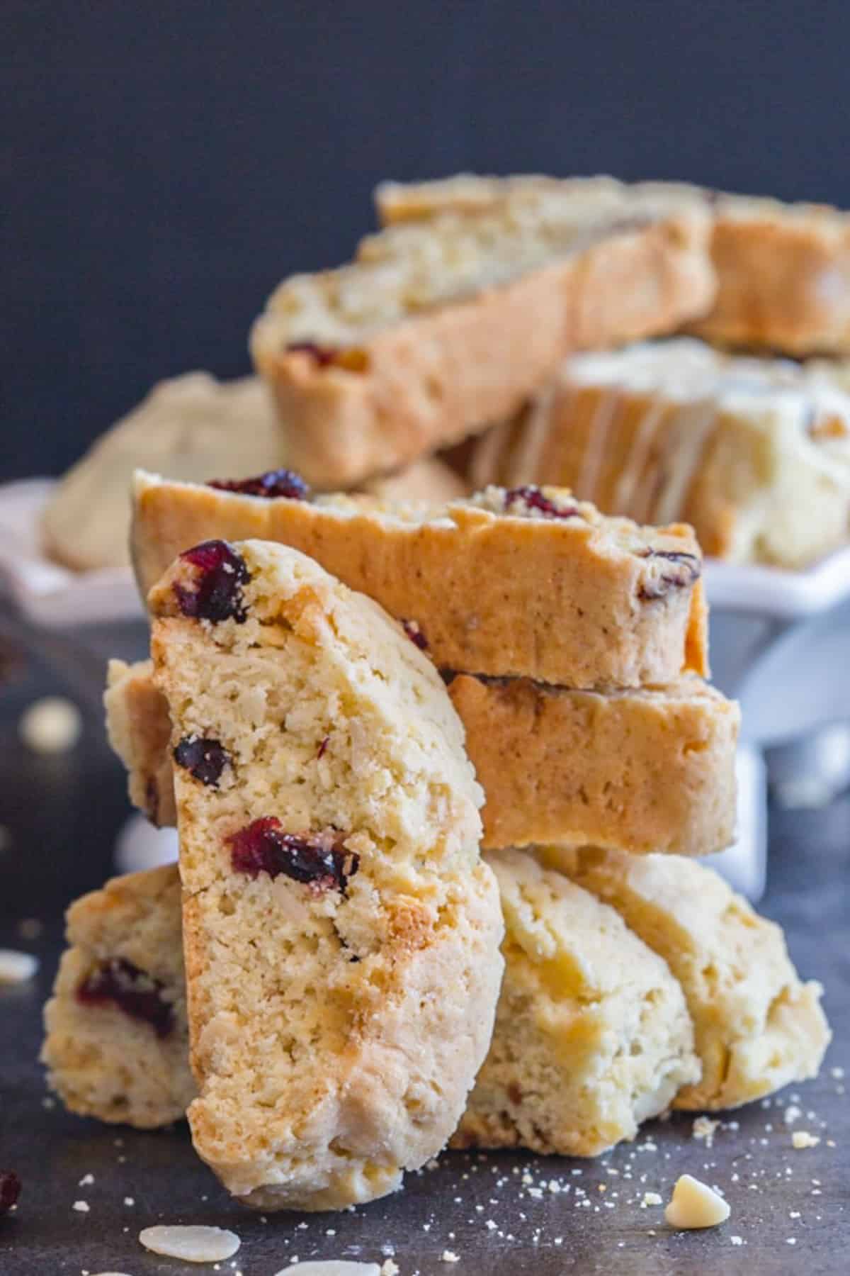 Cranberry almond biscotti stacked with one leaning against them.