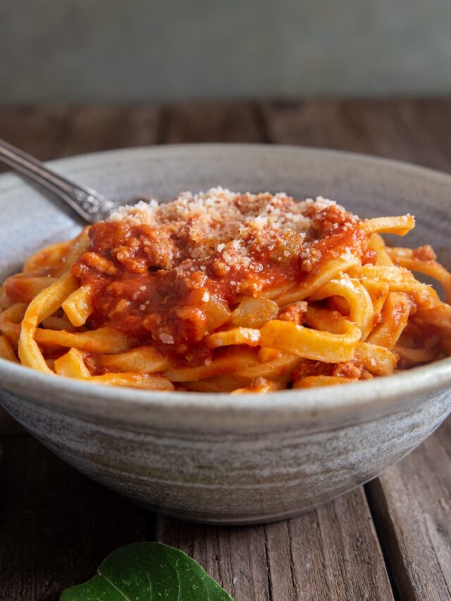 Bolognese sauce in a grey bowl.