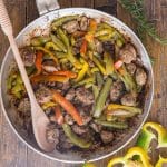 sausage and peppers in a silver pan