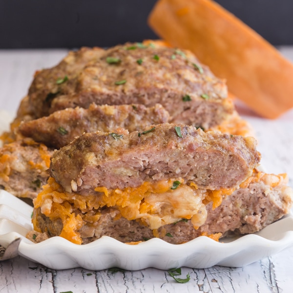 sliced stuffed meatloaf on a white dish
