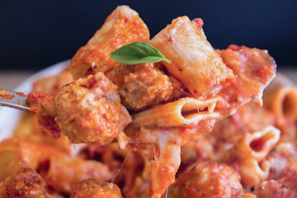 Turkey meatball casserole on a spoon.