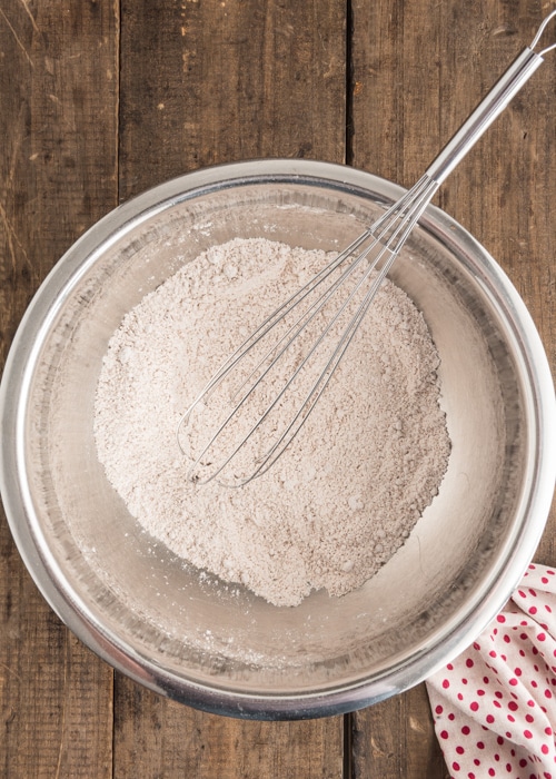 Whisking the dry ingredients in a silver bowl.