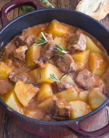 beef & potato stew in a large red and black pot