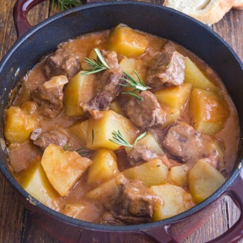 beef & potato stew in a large red and black pot