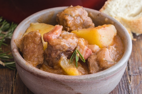 beef and potato stew in a white bowl