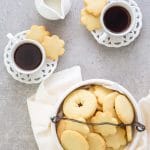 Italian butter cookies in a cookie bowl with 2 cups of expresso
