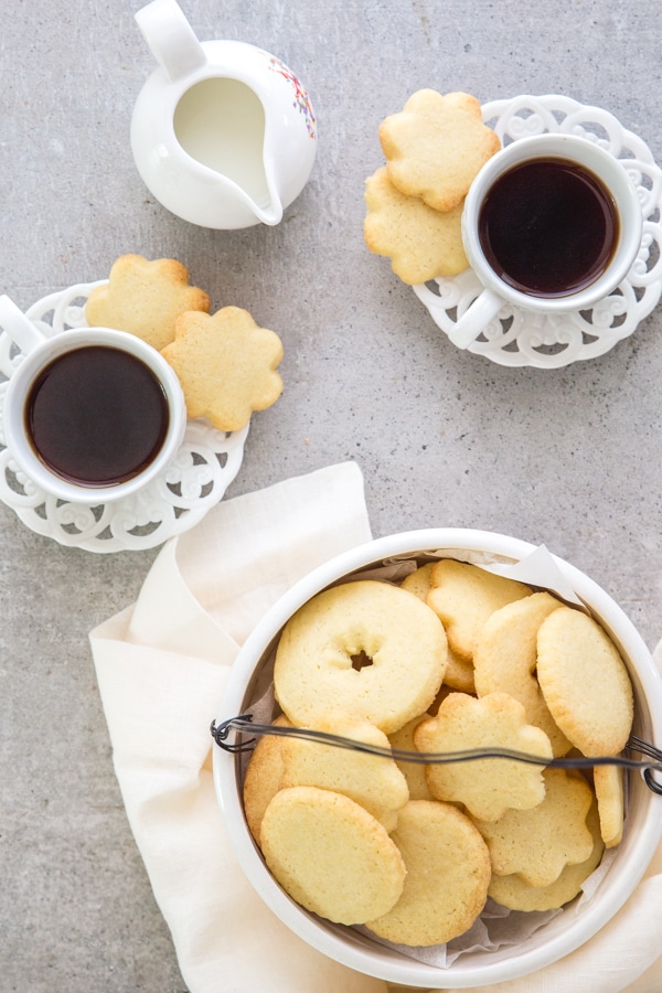 Italian butter cookies in a cookie bowl with 2 cups of expresso 