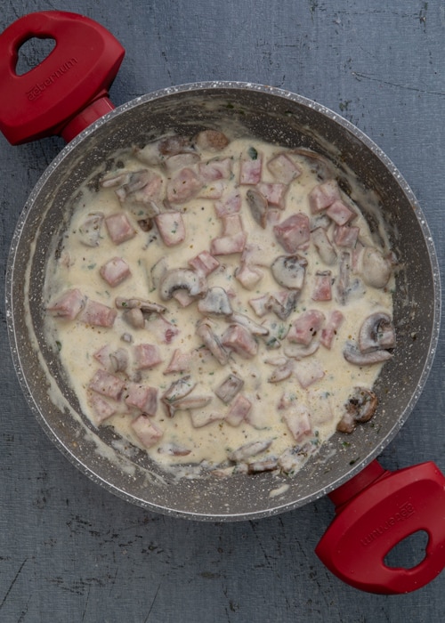 The sauce and the mushrooms in the pan.