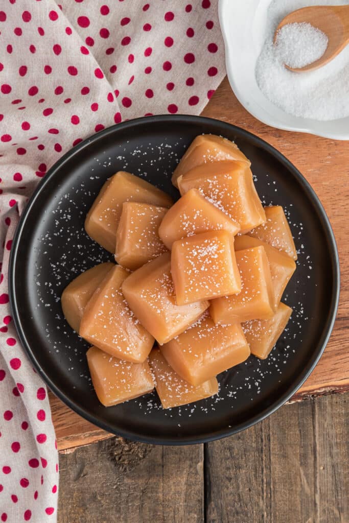 Caramels on a black plate.