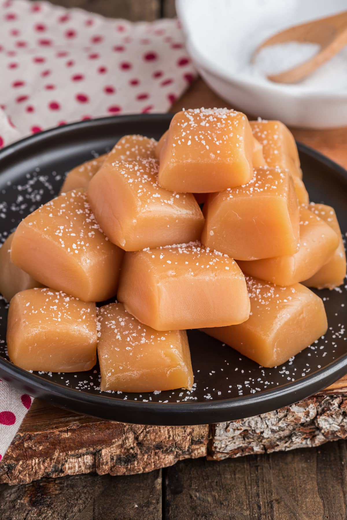 Caramels on a black plate.