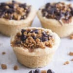 Three cookie cup cookies on parchment paper.
