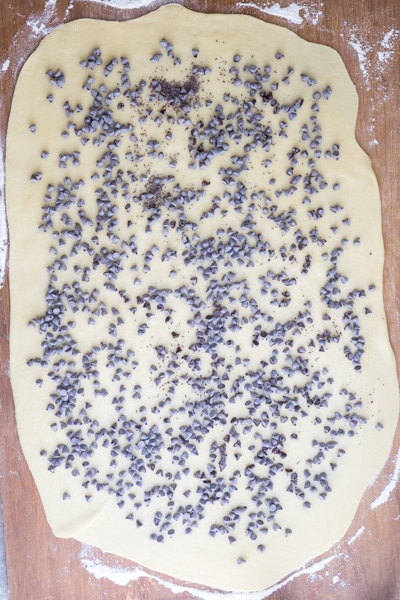 rolling the dough into a rectangle and sprinkling with chocolate chips