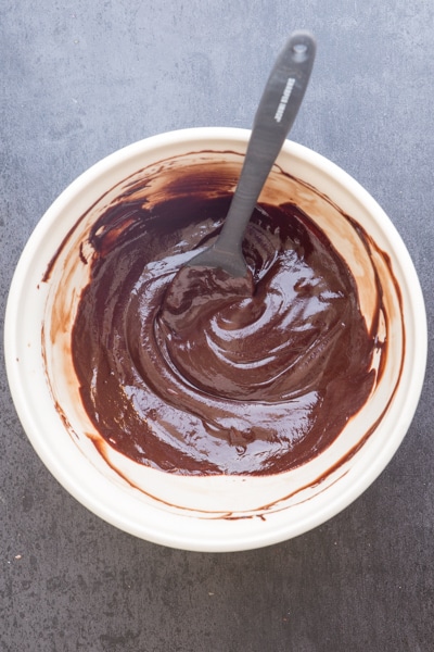 mixing the melted chocolate, cream and liqueur