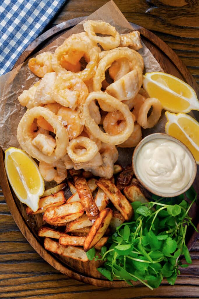Fried seafood on a plate with fries.