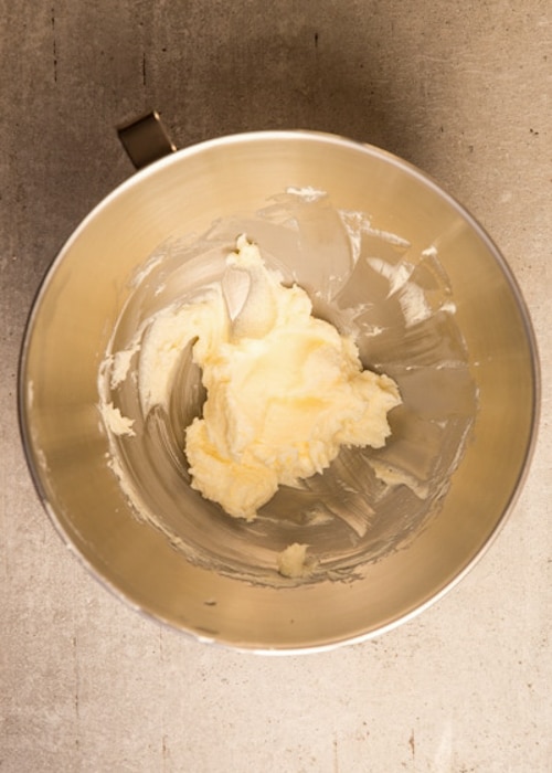 Beat the butter and sugar in a silver mixing bowl.