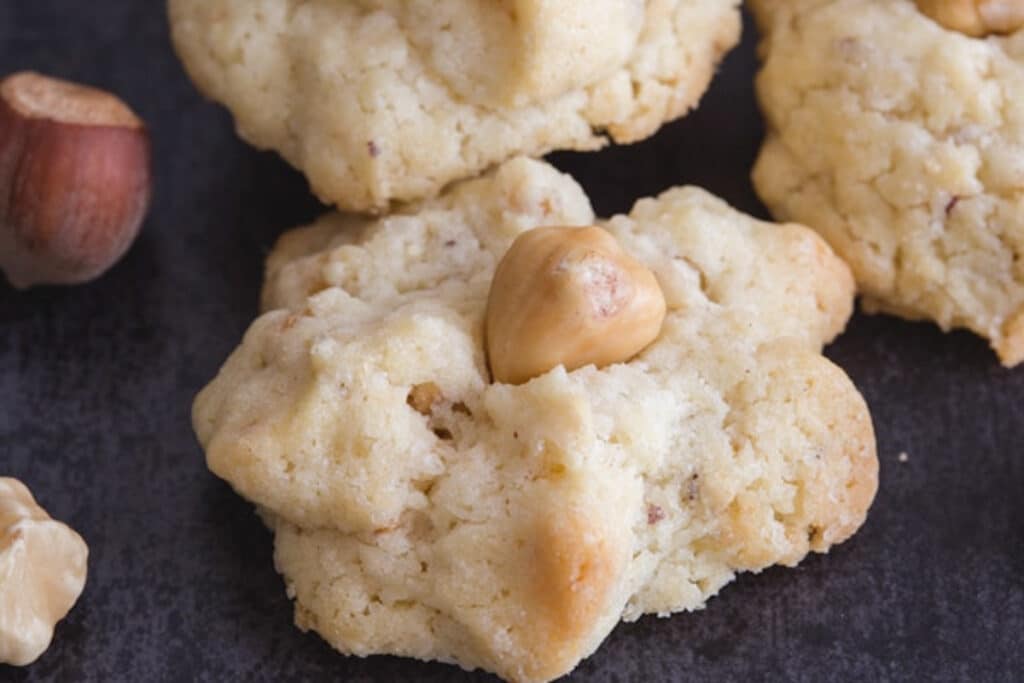 Hazelnut cookies on a black board.