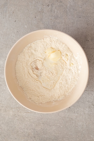 mixing the dry ingredients, butter and egg in a white bowl
