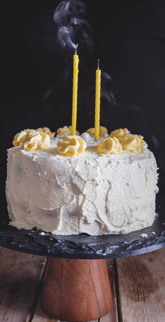 Vanilla cake with two candles blown out.