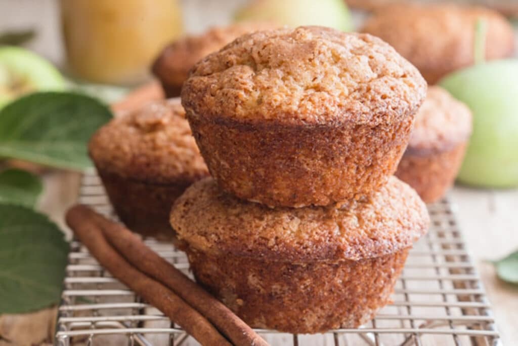 Two muffins stacked on a wire rack.