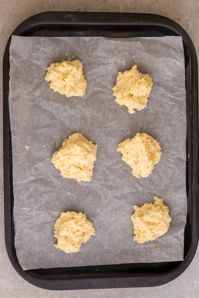 placing dough on parchment paper lined cookie sheet