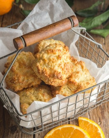 drop biscuits in a wire basket with slices of oranges