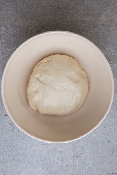 the dough in a lightly oiled white bowl ready for rising